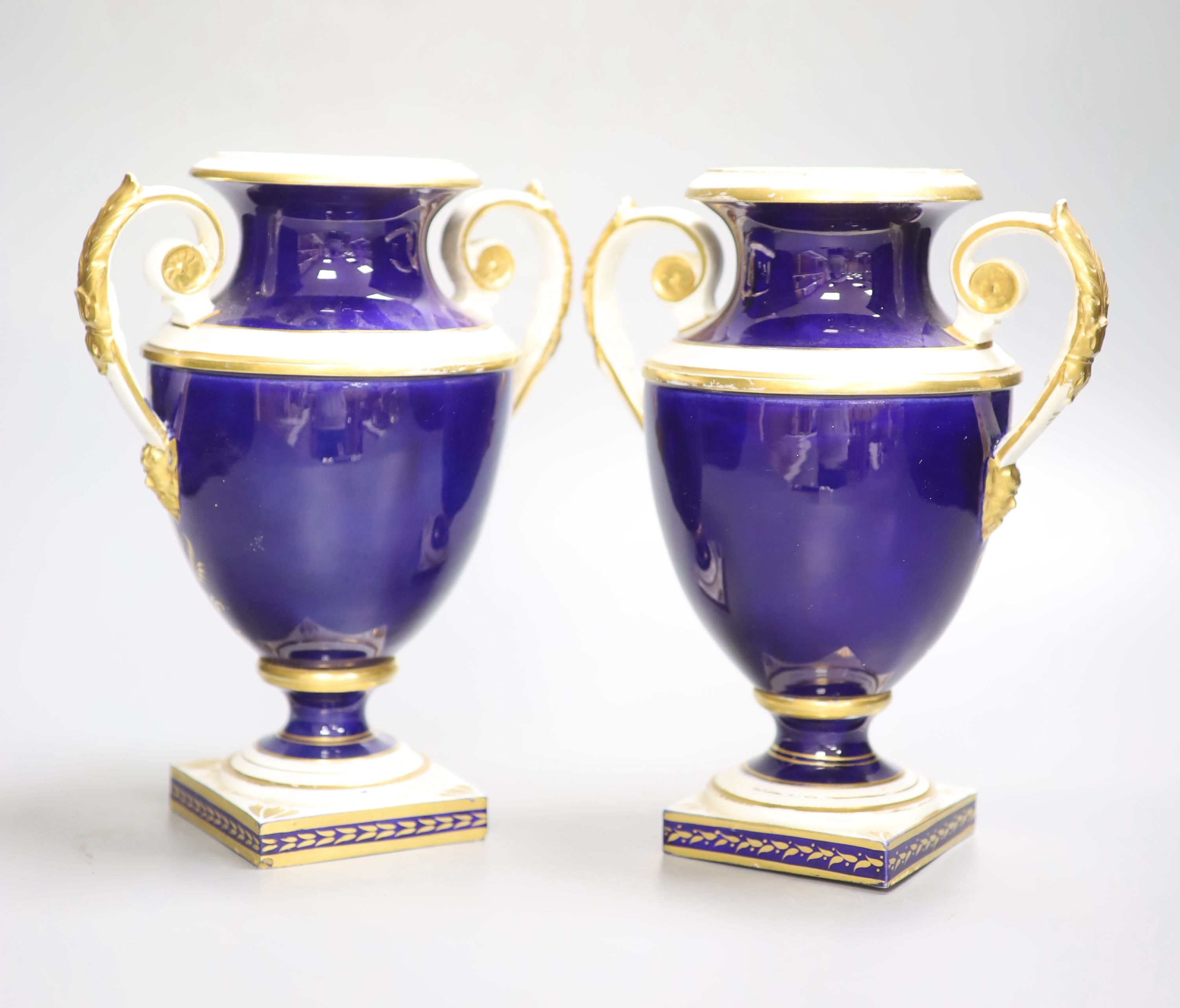 A Derby pair of two handled shield vases, painted with scenes of Old Castle Oxenford and Warwick Castle, height 22cm